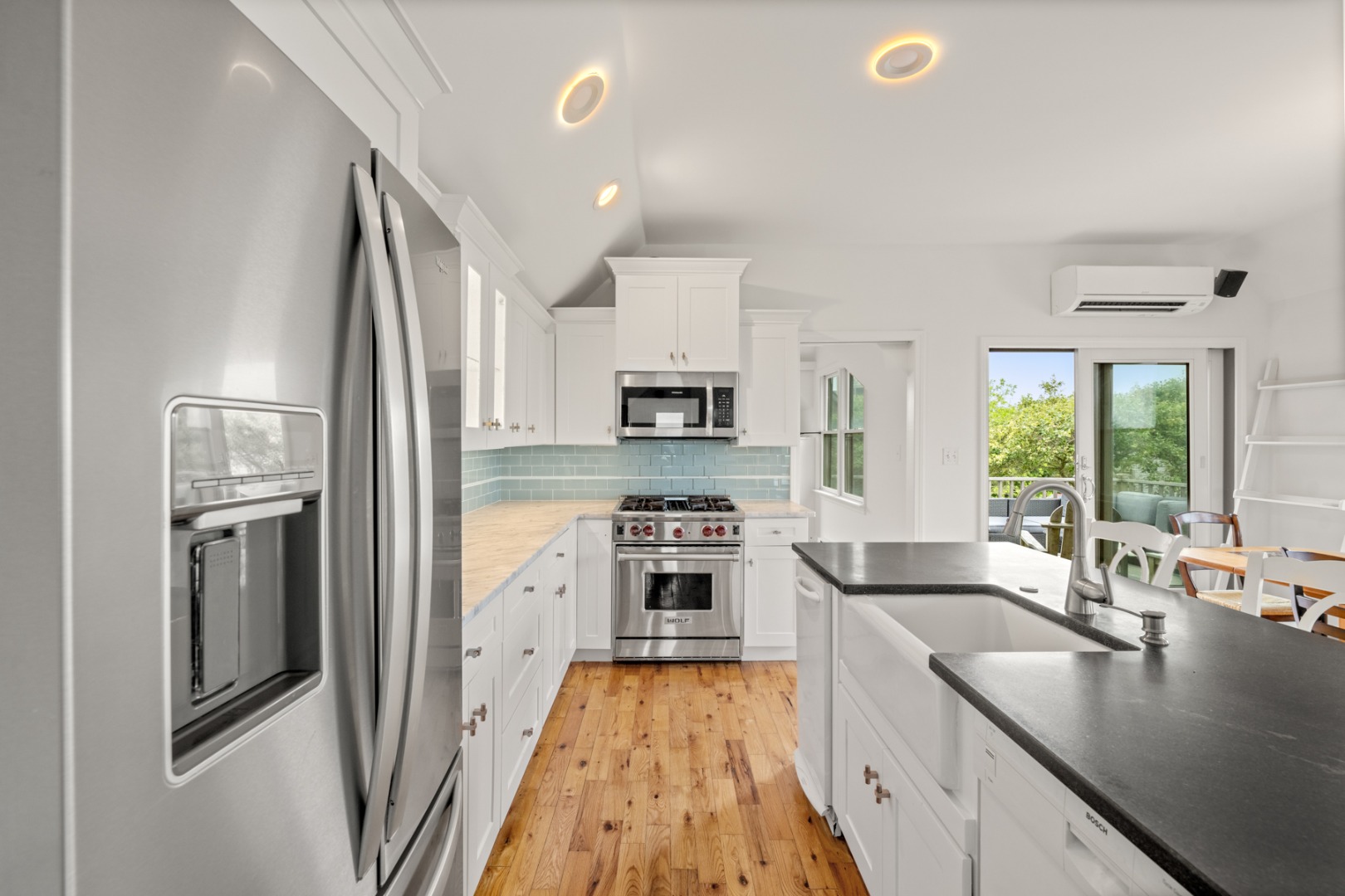 4 Berkley Street Nantucket, MA 02554 - Photo 22 of 47 a kitchen with stainless steel appliances granite countertop a refrigerator a stove and a sink with large window