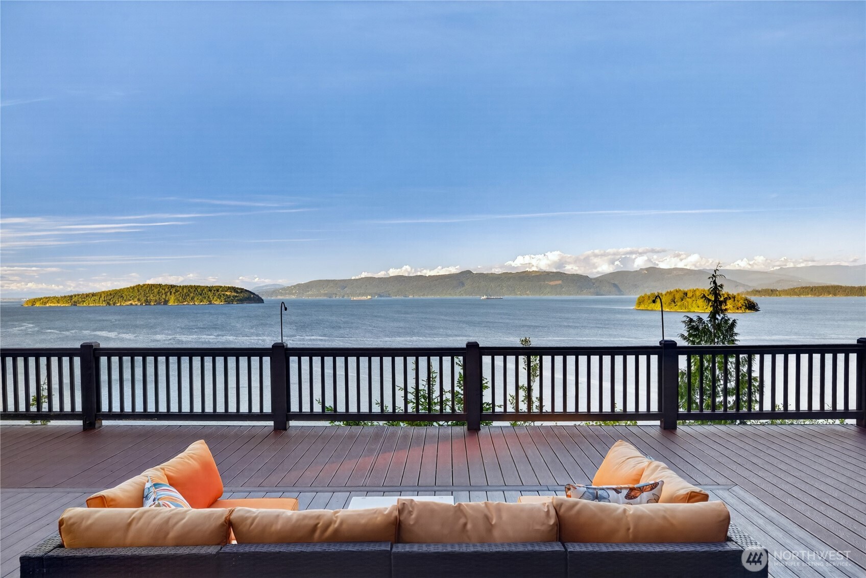 4623 Guemes Island Road Anacortes, WA 98221 - Photo 1 of 40 a balcony with wooden floor and outdoor seating