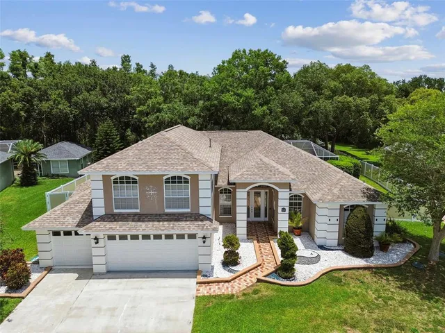 a aerial view of a house with garden and porch