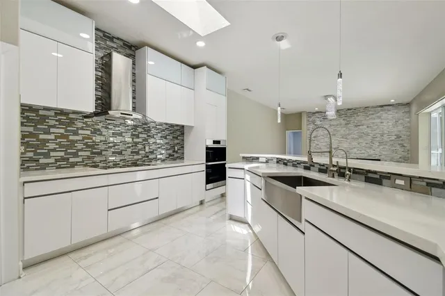 a large kitchen with a large window and stainless steel appliances
