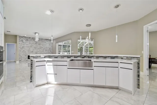 a kitchen with a sink and a stove top oven