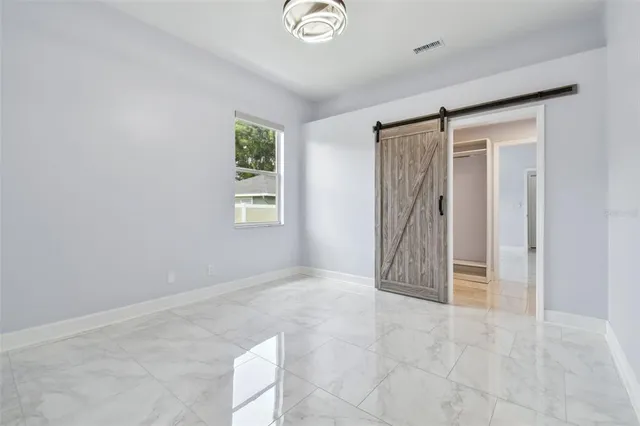 a view of a house with a big yard and potted plants