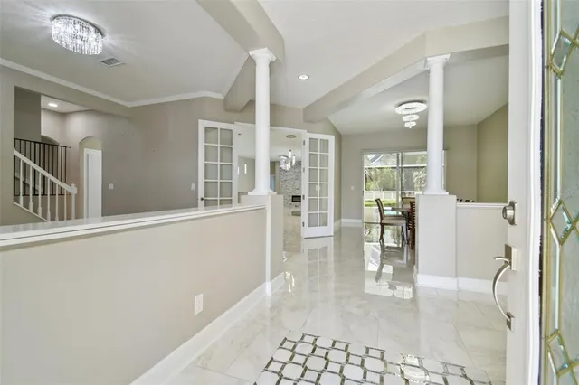 a view of a dining room with furniture and a chandelier