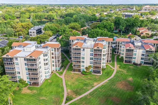 an aerial view of a house with outdoor space and lake view