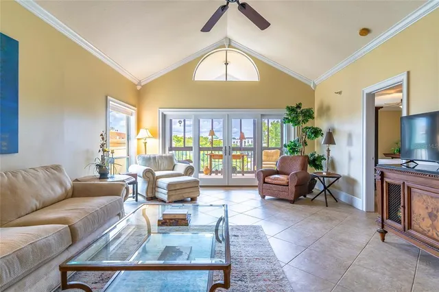 a living room with furniture a flat screen tv and a large window