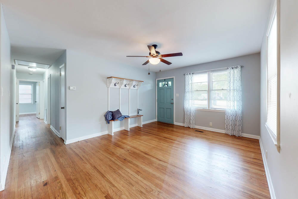 Living room with hardwood floors & charming mud bench seat!