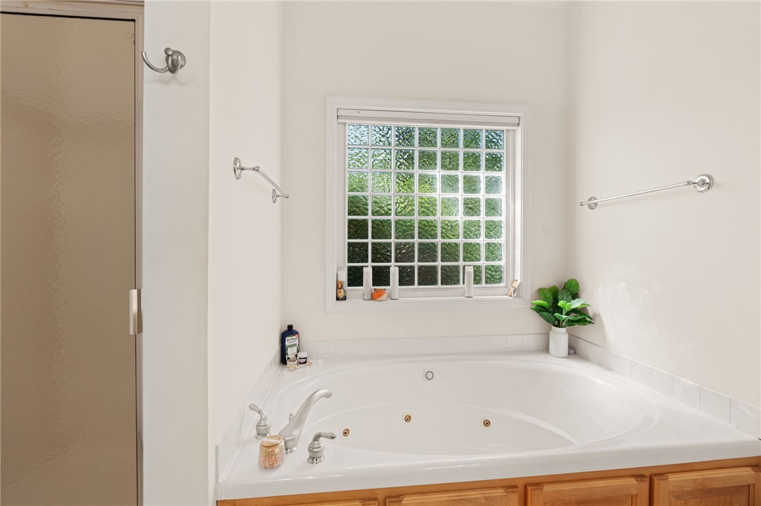 108 Winterbrook Circle Seneca, SC 29678 - Photo 24 of 40 Indulge in a tranquil soak in this generous corner spa tub, illuminated by a privacy glass window.