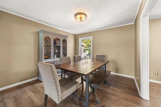 a view of a dining room with furniture and a potted plant