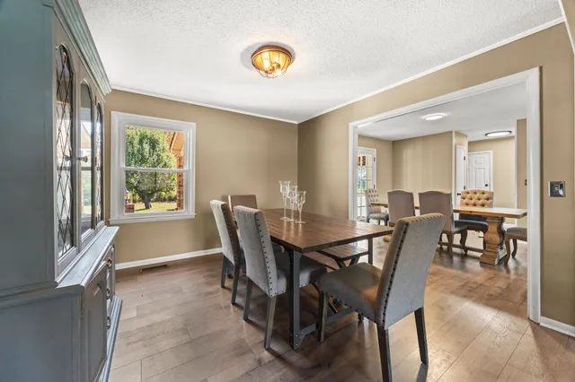 a view of a dining room with furniture and wooden floor