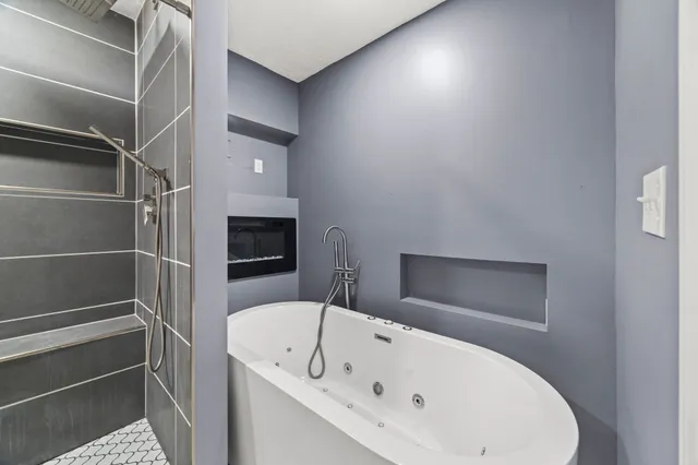 a bathroom with a bathtub and a shower