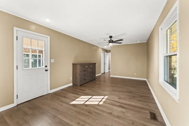 wooden floor in an empty room with a window