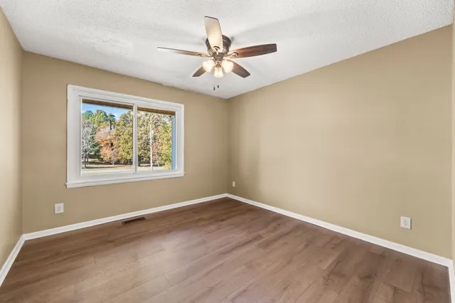 a bathroom with a granite countertop sink mirror vanity and a toilet
