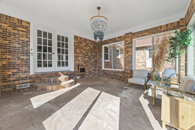 a view of house with outdoor space and trees in the background