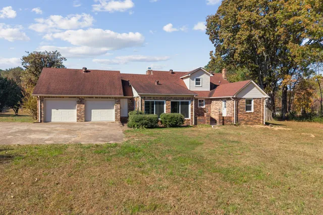 a view of a backyard with sitting area