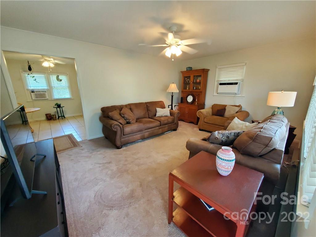 4681 Emerald Drive Morganton, NC 28655 - Photo 19 of 38 a living room with furniture and a chandelier