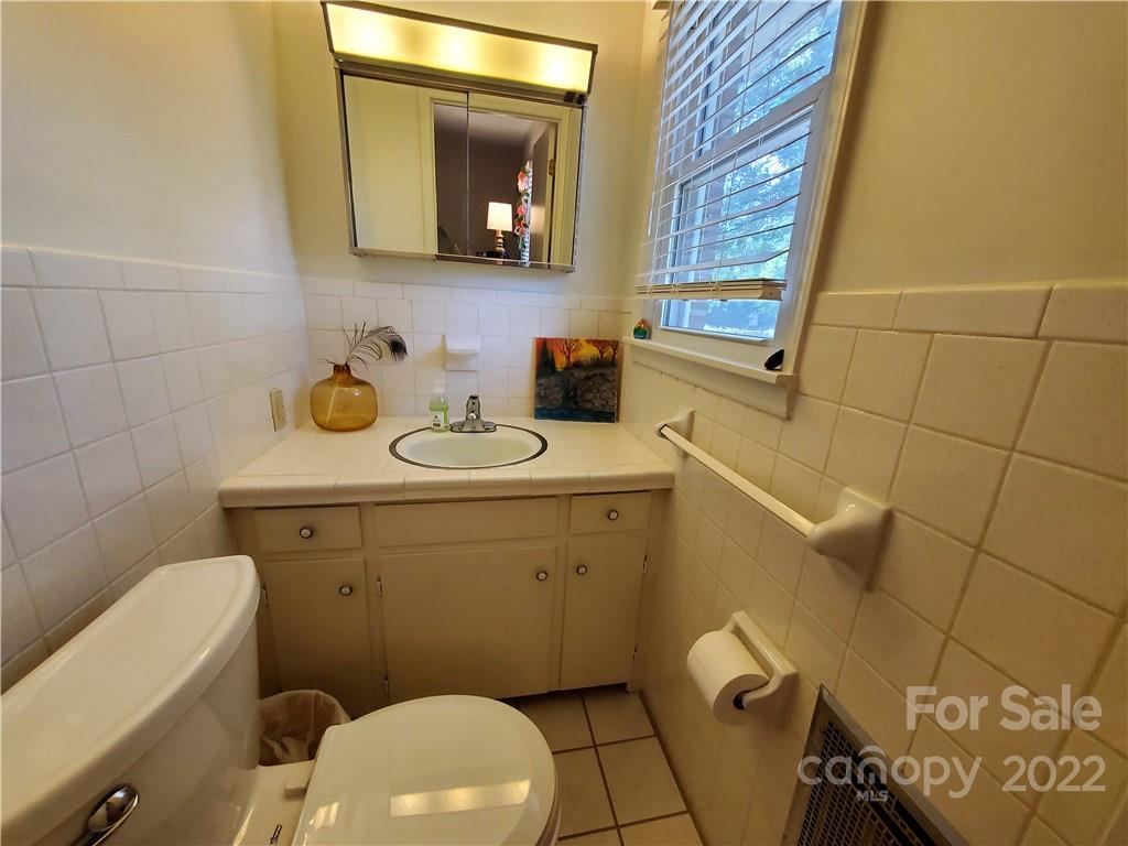 4681 Emerald Drive Morganton, NC 28655 - Photo 24 of 38 a bathroom with a toilet sink and mirror