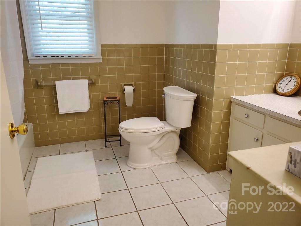 4681 Emerald Drive Morganton, NC 28655 - Photo 28 of 38 a bathroom with a sink a toilet and a mirror