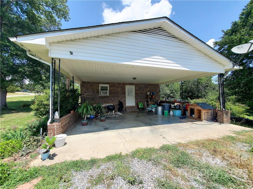 4681 Emerald Drive Morganton, NC 28655 - Photo 5 of 38 a patio with a table and chairs under an umbrella