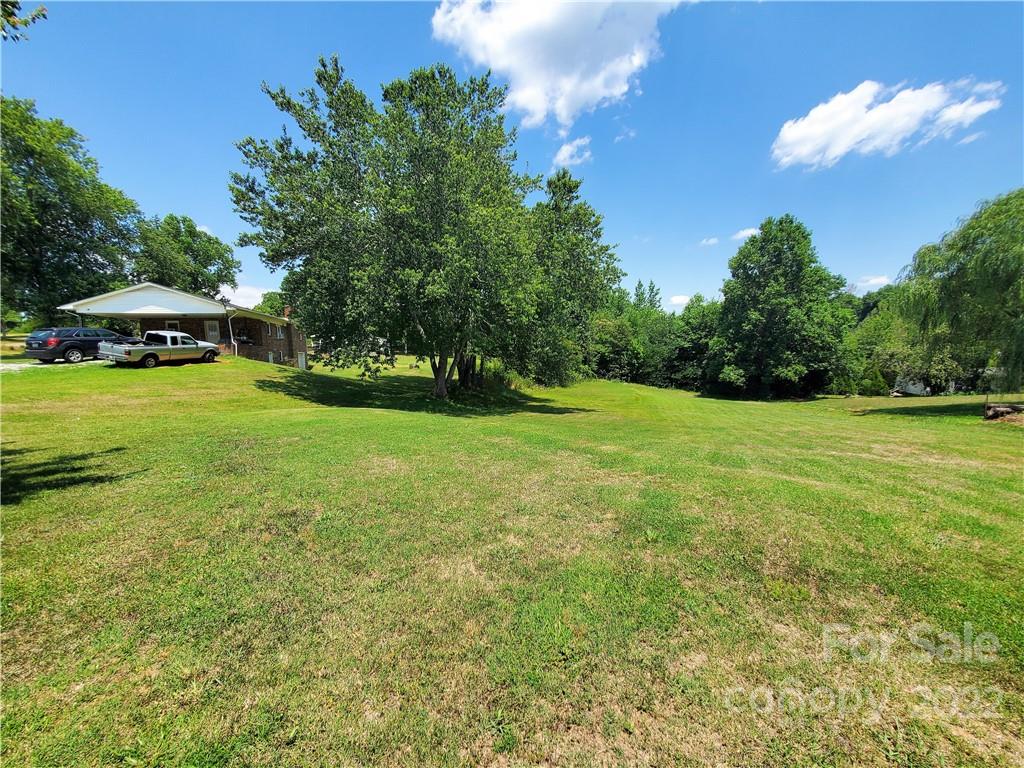 4681 Emerald Drive Morganton, NC 28655 - Photo 6 of 38 a view of a green yard with a house in the background