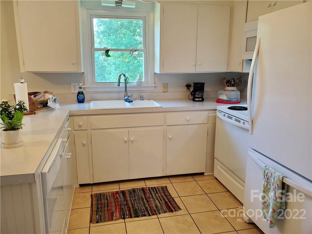 4681 Emerald Drive Morganton, NC 28655 - Photo 7 of 38 a kitchen with a sink a window and cabinets