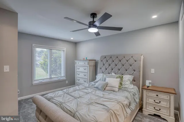 a bedroom with a bed and a night stand