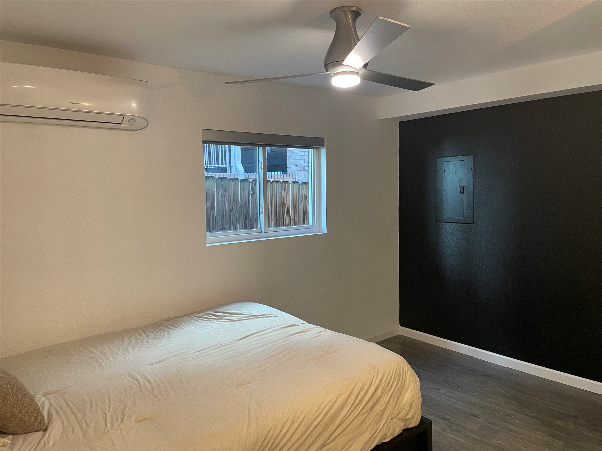 2220 Leon Street, Unit 103 Austin, TX 78705 - Photo 4 of 15 a bedroom with a bed and a chandelier