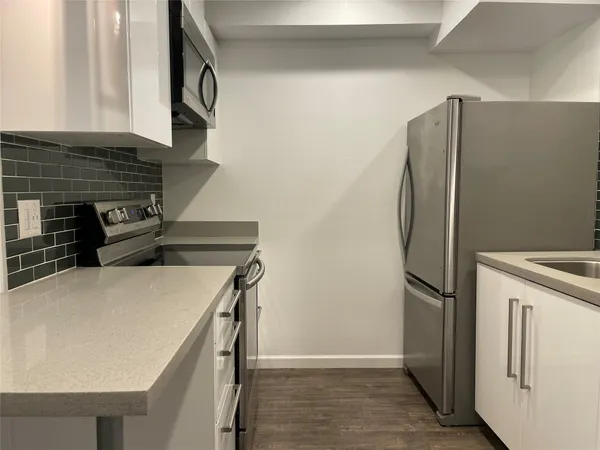 a kitchen with stainless steel appliances a refrigerator and a stove