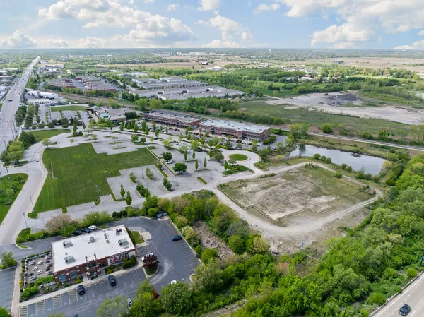 an aerial view of residential houses with outdoor space and river
