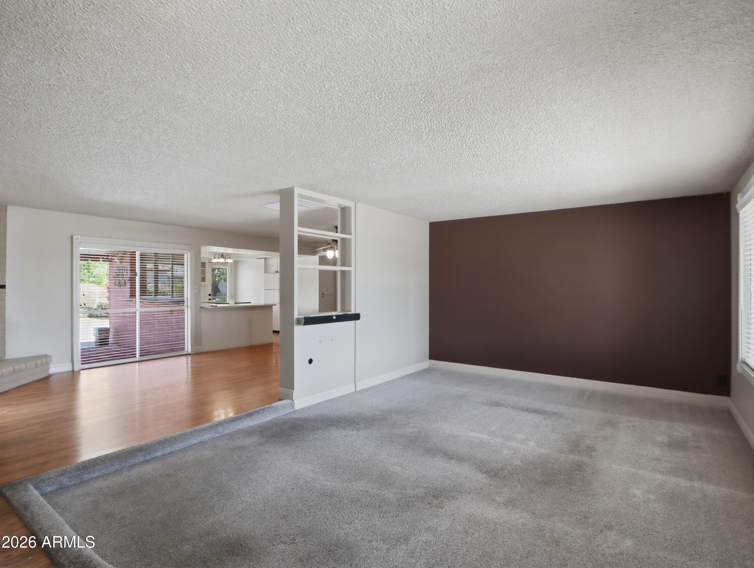 450 Cascada Road Litchfield Park, AZ 85340 - Photo 6 of 40 an empty room with wooden floor and windows