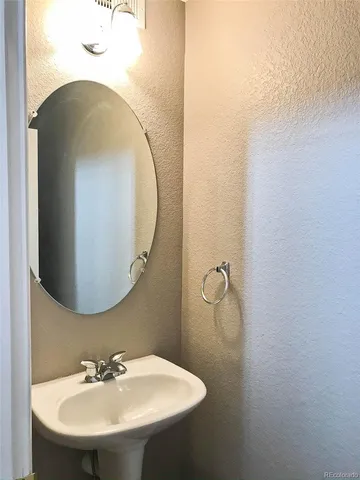 a bathroom with a sink and mirror