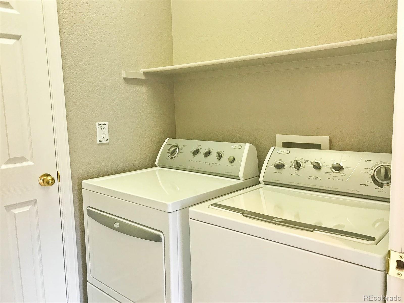 6753 South Winnipeg Circle, Unit 101 Aurora, CO 80016 - Photo 19 of 36 a utility room with dryer and washer