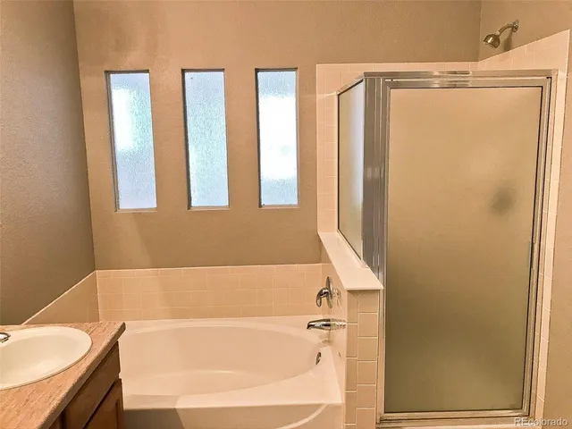 a bathroom with a bathtub and a shower
