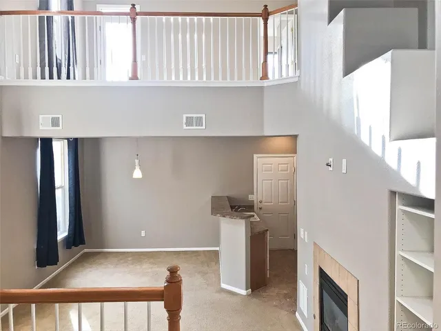 a view of a livingroom with furniture and staircase