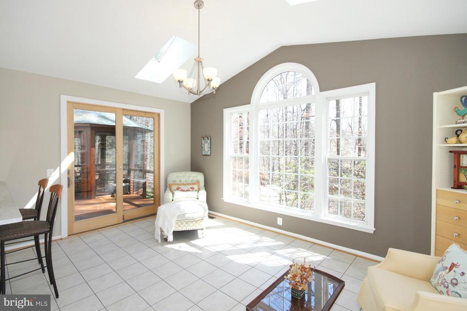 6253 Rolling Spring Court Springfield, VA 22152 - Photo 14 of 30 a living room with furniture a chandelier and a large window