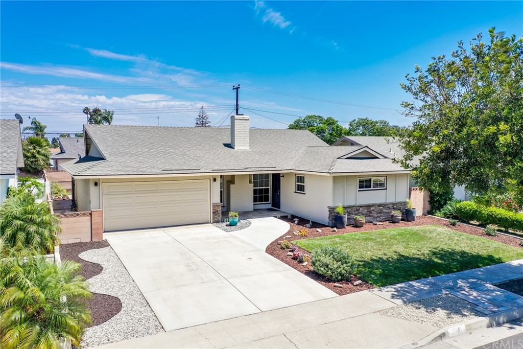 16632 Rhone Lane Huntington Beach, CA 92647 - Photo 1 of 1 a front view of a house with a garden and yard