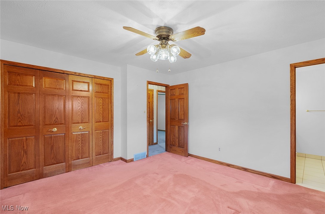 5611 Ralston Drive Parma, OH 44129 - Photo 17 of 39 Unfurnished bedroom featuring carpet flooring, a closet, and a ceiling fan