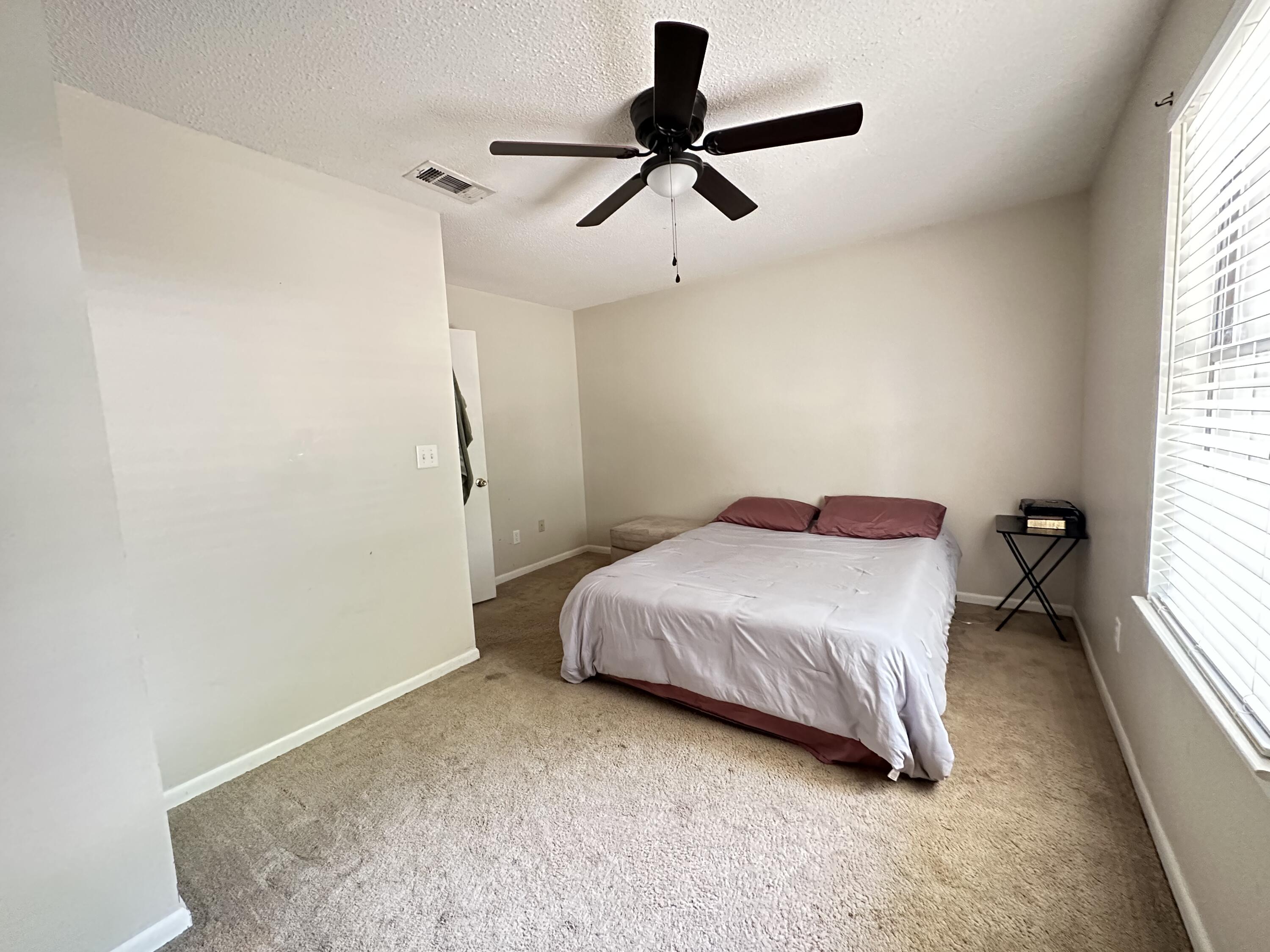 4872 Griffith Mill Road Holt, FL 32564 - Photo 7 of 15 a bedroom with a bed and a window