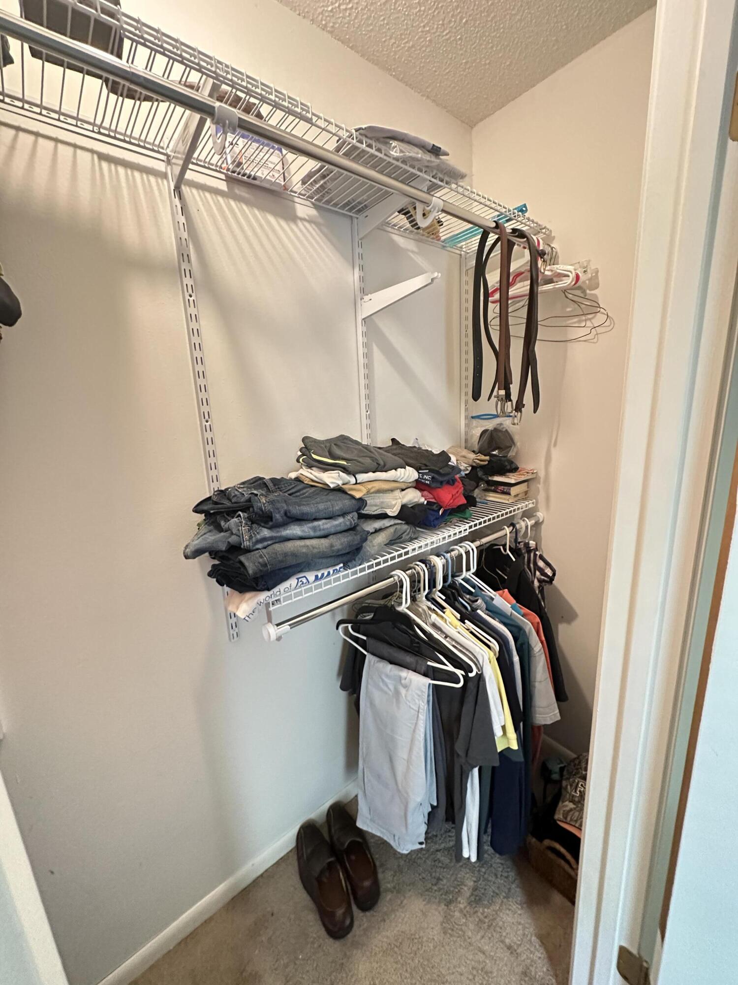 4872 Griffith Mill Road Holt, FL 32564 - Photo 8 of 15 a view of walk in closet with clothes and shoes