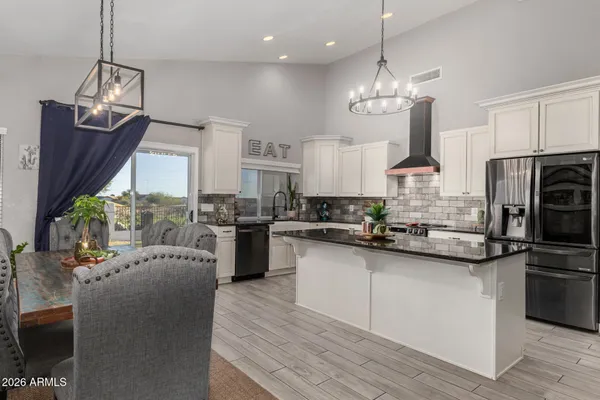 a bedroom with a bed and a chandelier fan