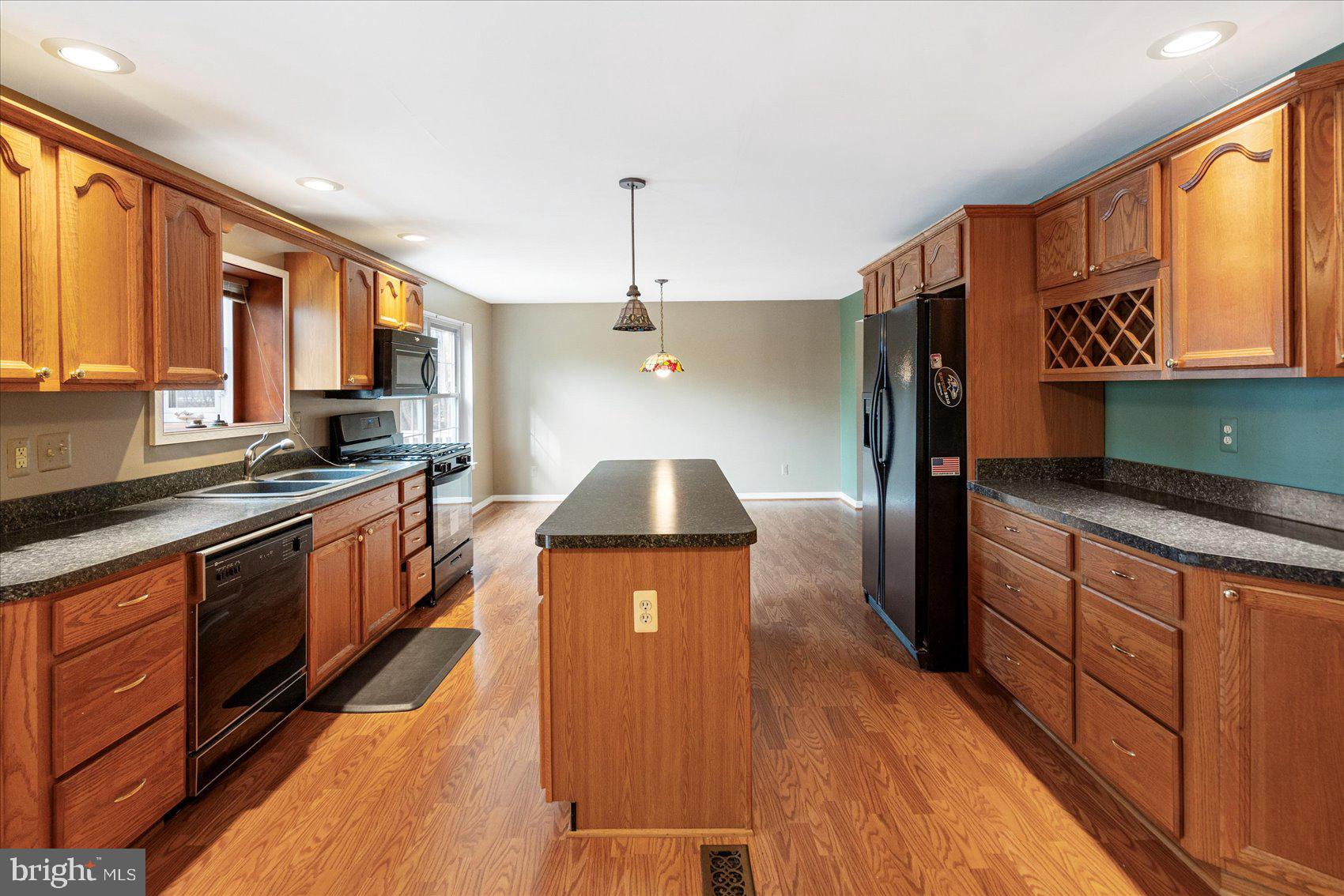 4003 Jacinth Way Baltimore, MD 21236 - Photo 11 of 43 a kitchen with stainless steel appliances granite countertop a sink a stove top oven a counter space and cabinets