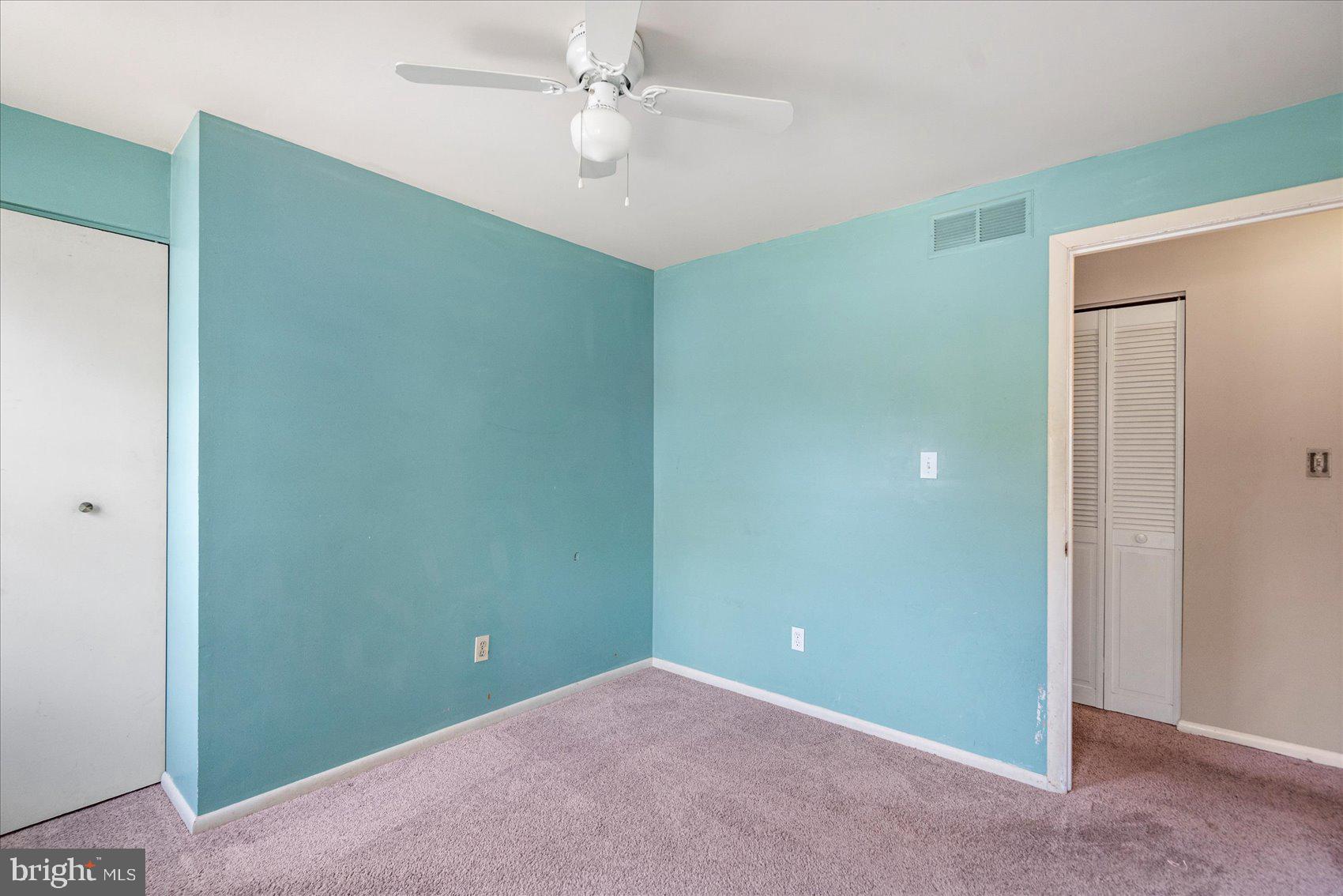 4003 Jacinth Way Baltimore, MD 21236 - Photo 24 of 43 an empty room with a ceiling fan and a window