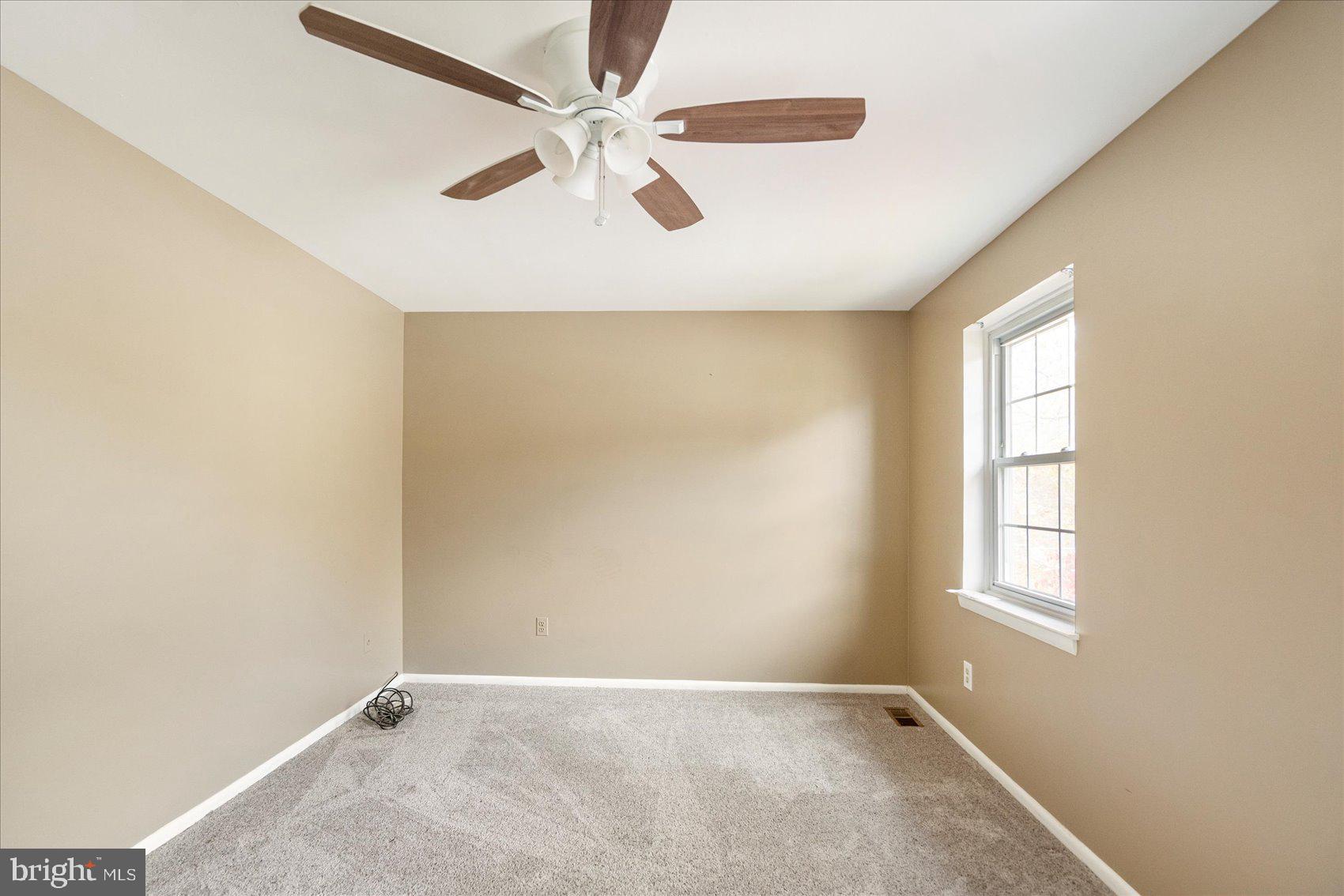 4003 Jacinth Way Baltimore, MD 21236 - Photo 26 of 43 an empty room with windows and fan