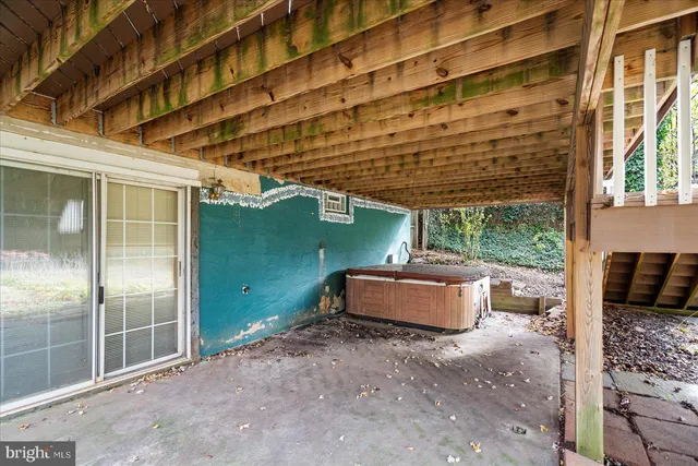 a backyard of a house with lot of potted plants and a fountain
