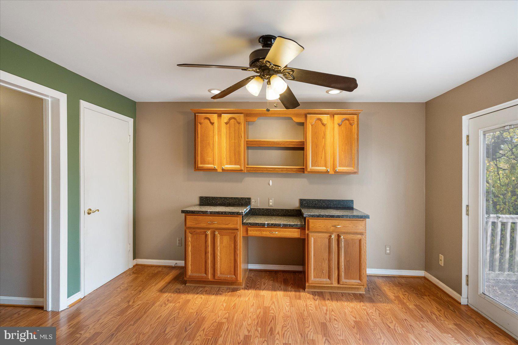 4003 Jacinth Way Baltimore, MD 21236 - Photo 9 of 43 a kitchen with stainless steel appliances granite countertop a hardwood floor a sink and a window