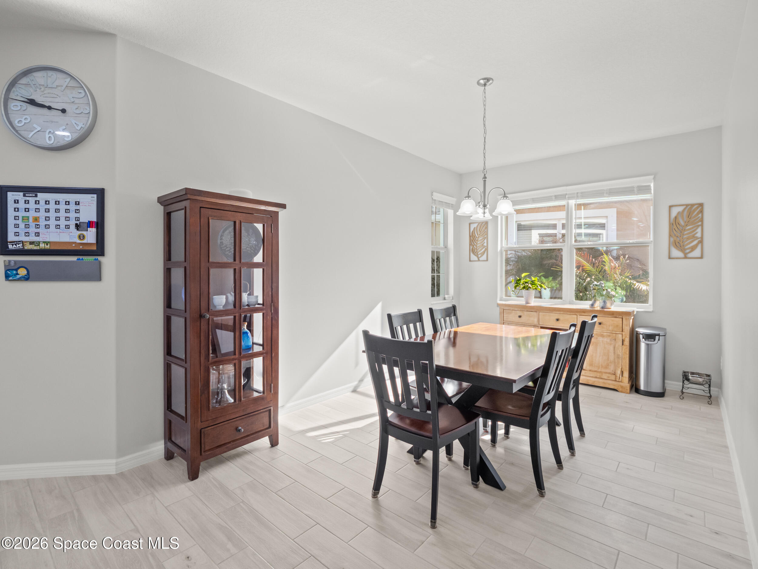 3363 Addison Drive Melbourne, FL 32940 - Photo 13 of 53 a view of a dining room with furniture window and wooden floor