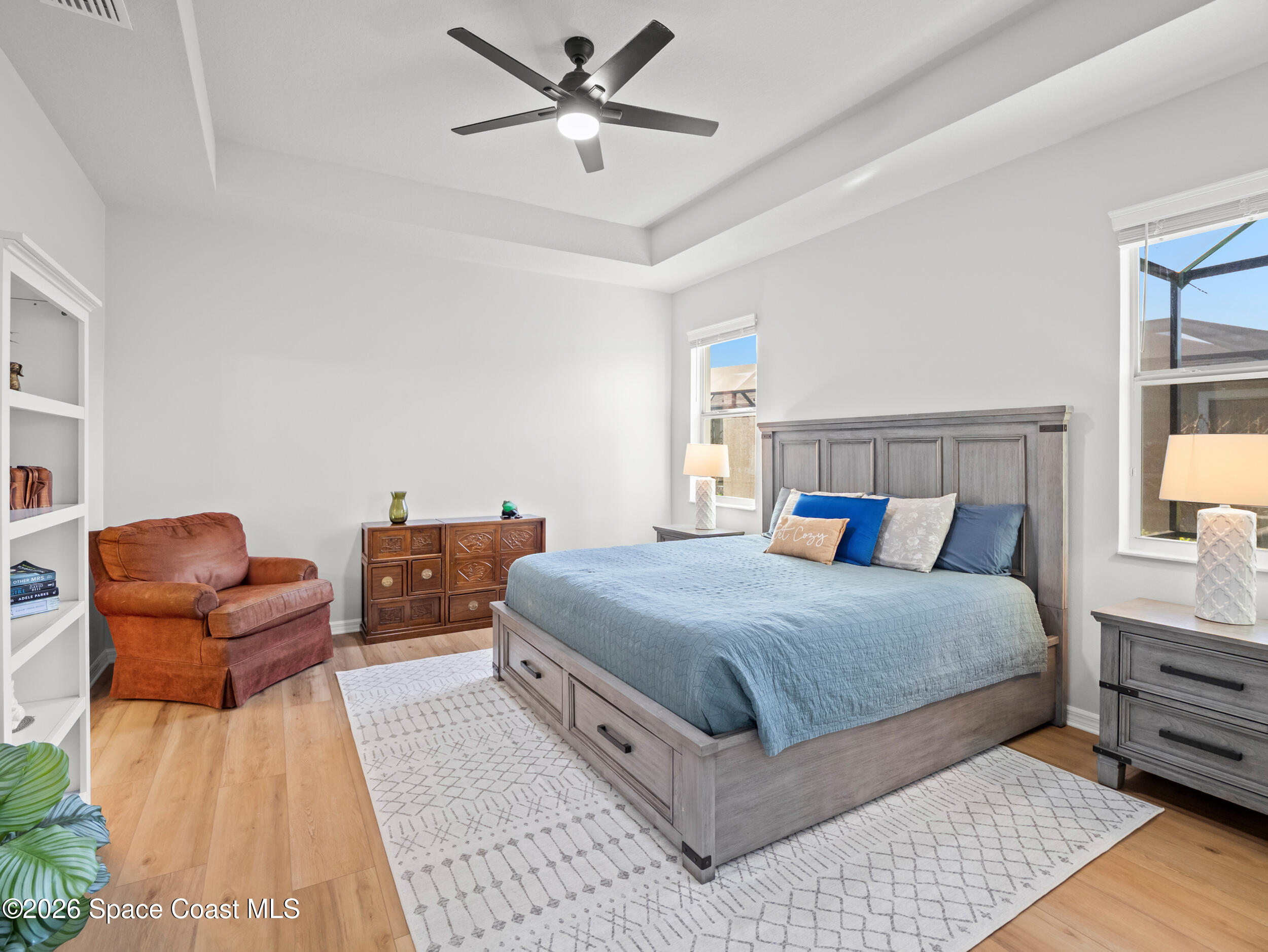 3363 Addison Drive Melbourne, FL 32940 - Photo 18 of 53 a bedroom with a bed and wooden floor