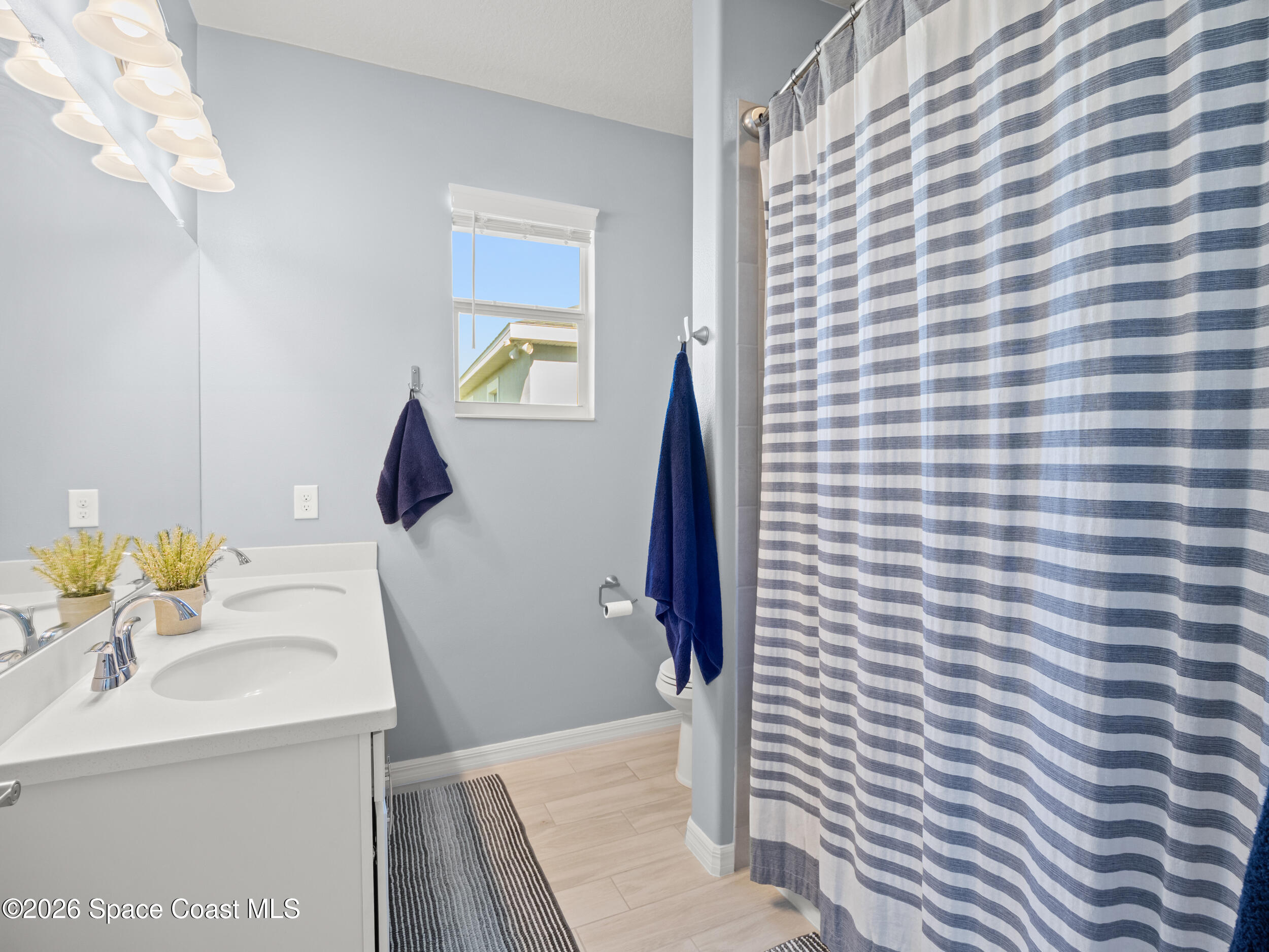 3363 Addison Drive Melbourne, FL 32940 - Photo 26 of 53 a bathroom with a sink and a mirror