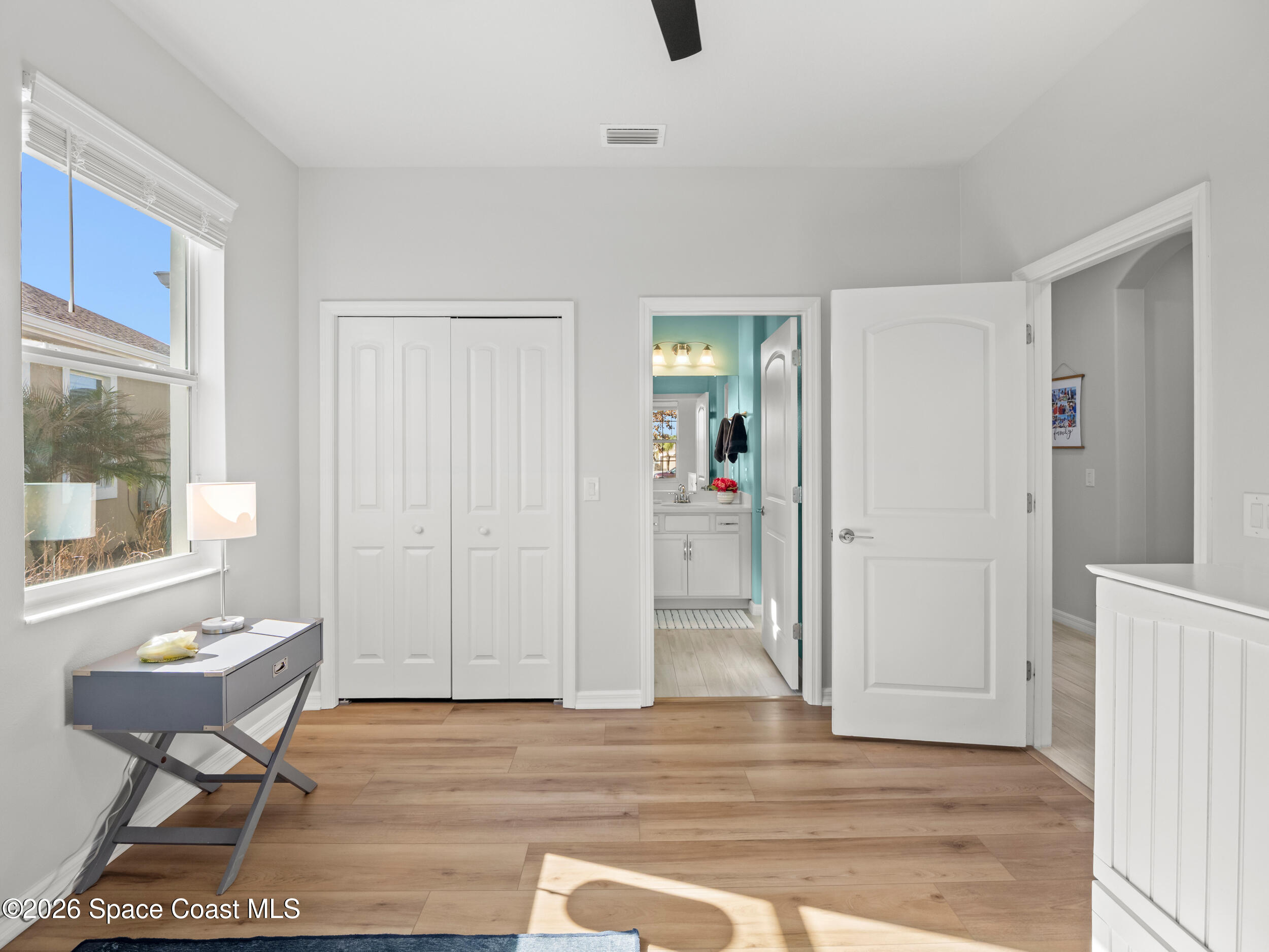 3363 Addison Drive Melbourne, FL 32940 - Photo 28 of 53 a view of an empty room with wooden floor and a window