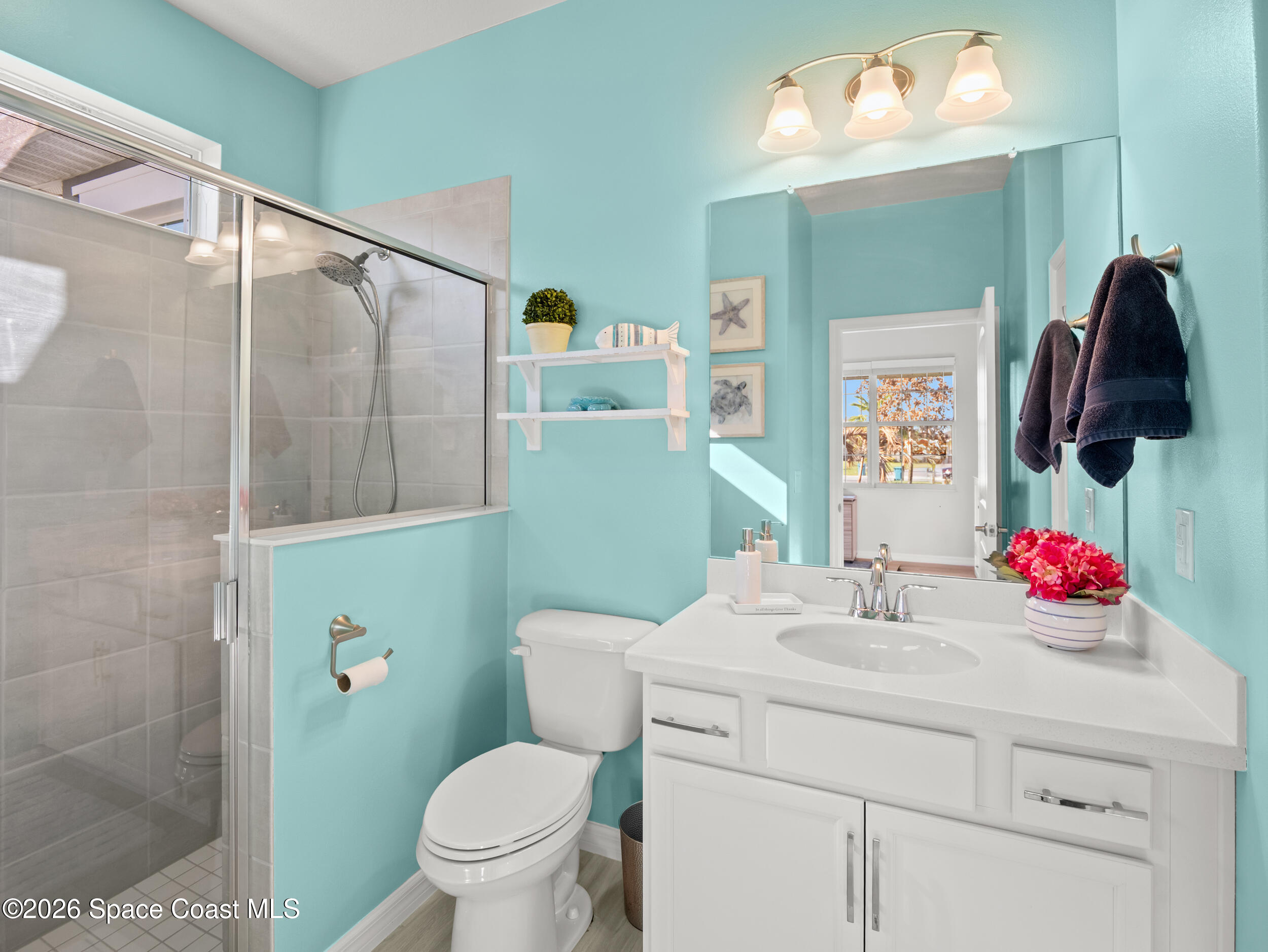 3363 Addison Drive Melbourne, FL 32940 - Photo 29 of 53 a bathroom with a sink vanity mirror and toilet