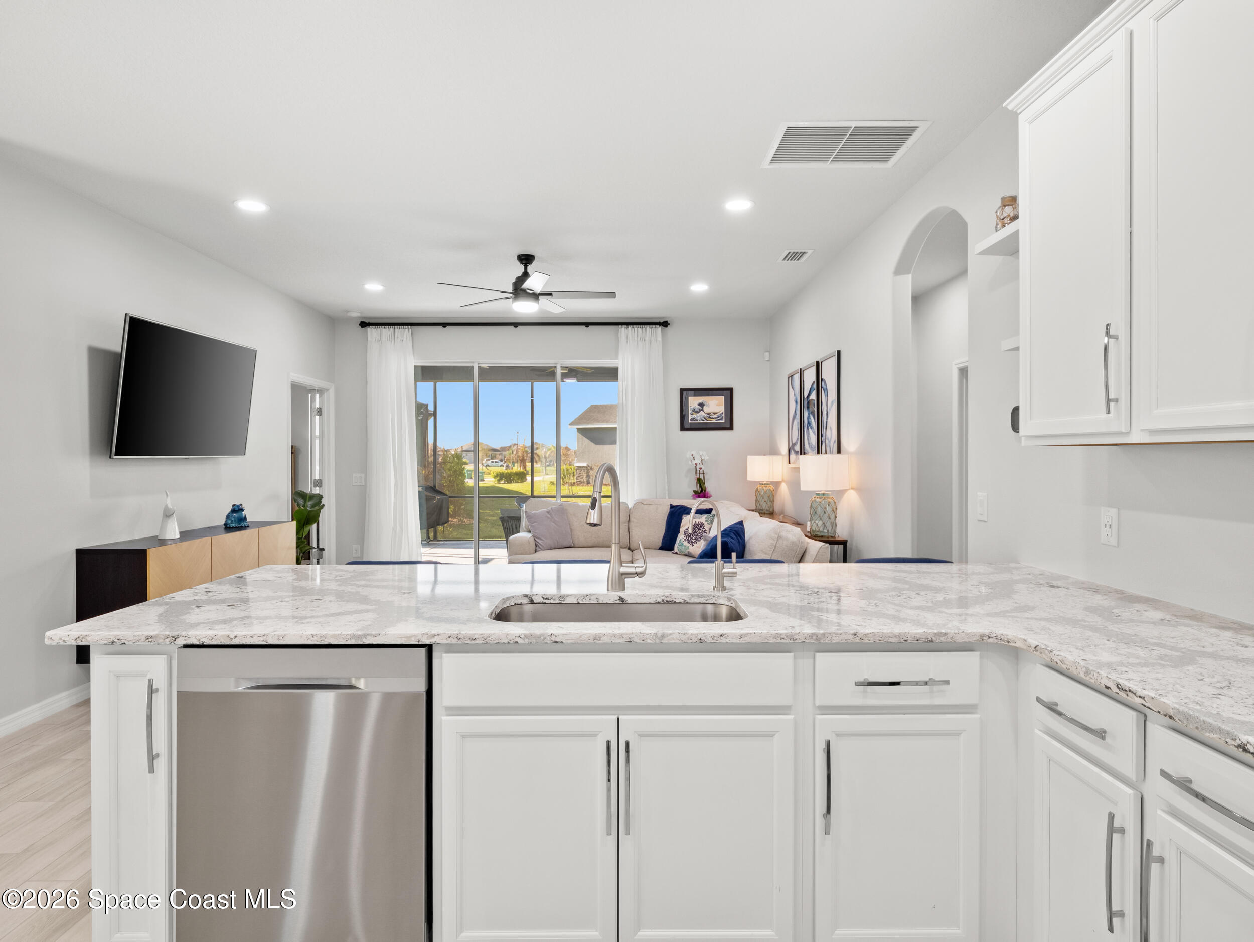3363 Addison Drive Melbourne, FL 32940 - Photo 7 of 53 a kitchen with sink microwave and cabinets